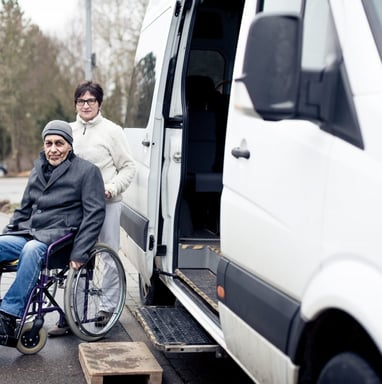 a man in a wheelchair wheel chair in front of a van