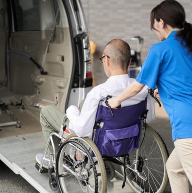 a man in a wheelchair is being assisted by a wheelchair